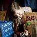 Ann Arbor resident Britten Stringwell writes on a sign at the Dirt Face table during the Shadow Art Fair at the Corner Brewery in Ypsilanti on Saturday, July 20. Daniel Brenner I AnnArbor.com